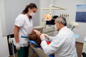 Dentists treating a patient at Saranda Dental Center
