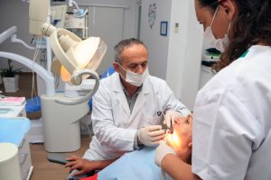 Dentist and assistant caring for a patient